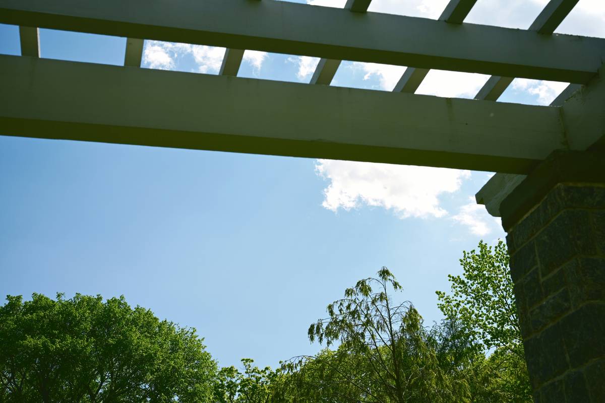 pergola structure arbor a b outdoor installed with concrete collars and stainless steel connectors on stone patio